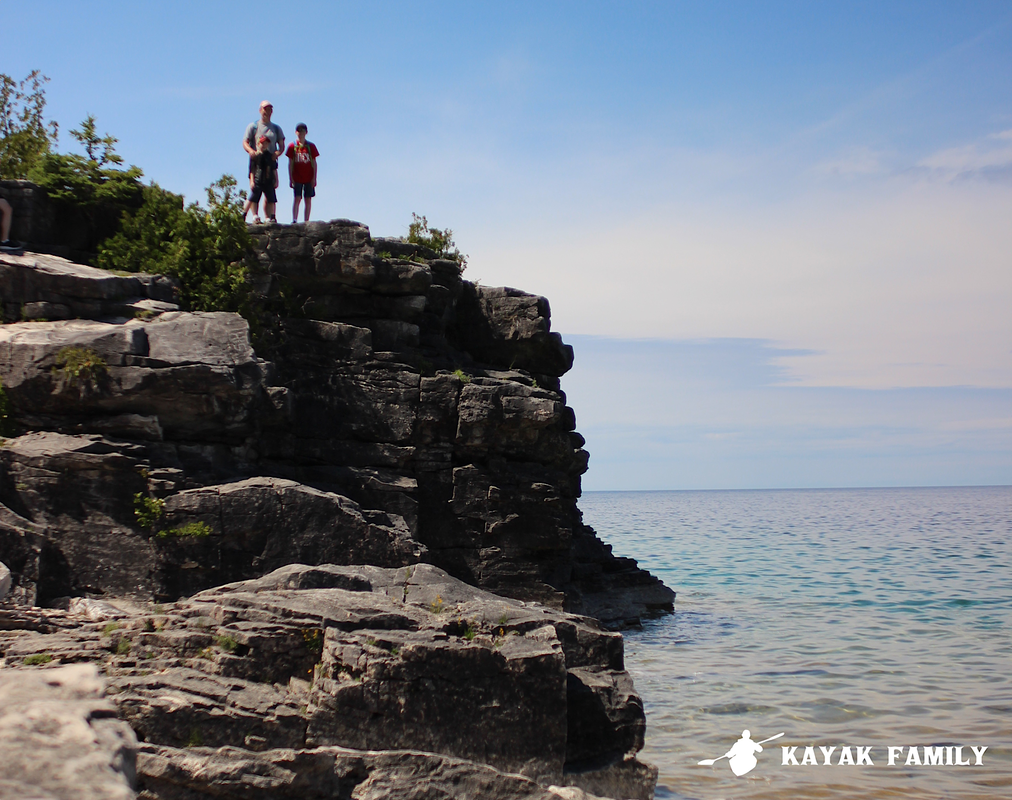 Hikers stand on Bruce Trail in Tobermory Bruce Peninsula National Park.