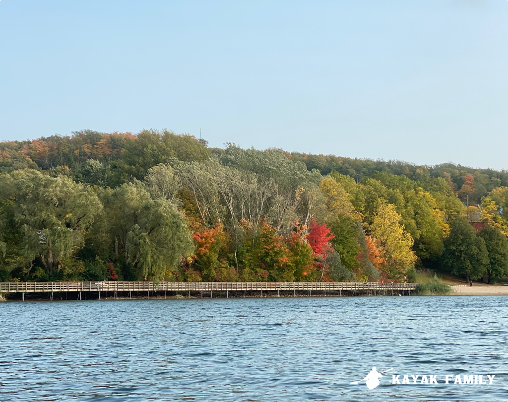 Kelso Conservation Area with fall colors above the board walk along the lake shore. 